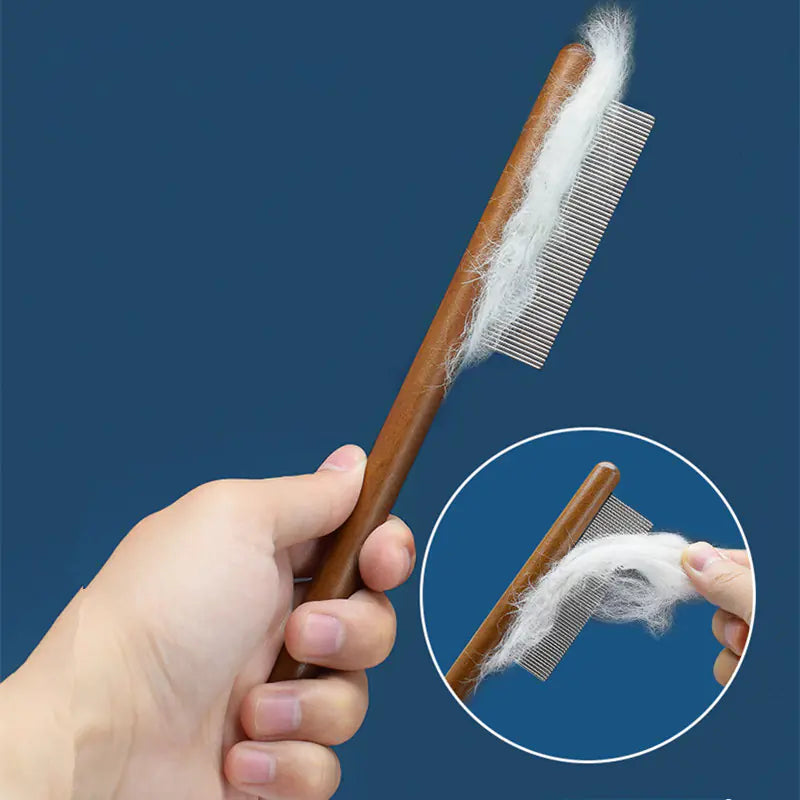 Comb held in hand while grooming a cat